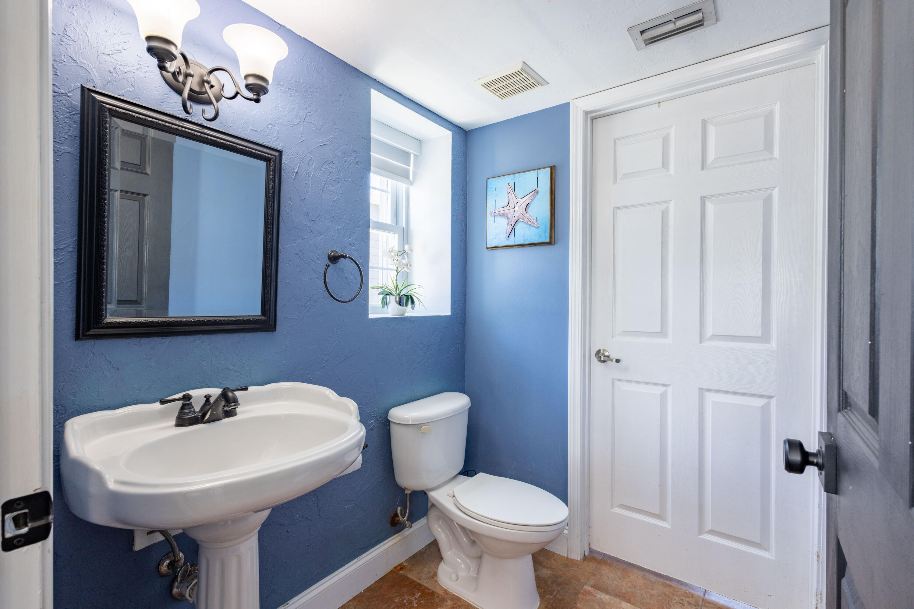 255 Mars Lane Key West, FL 33040 - Photo 9 of 43 a bathroom with a toilet a sink and mirror