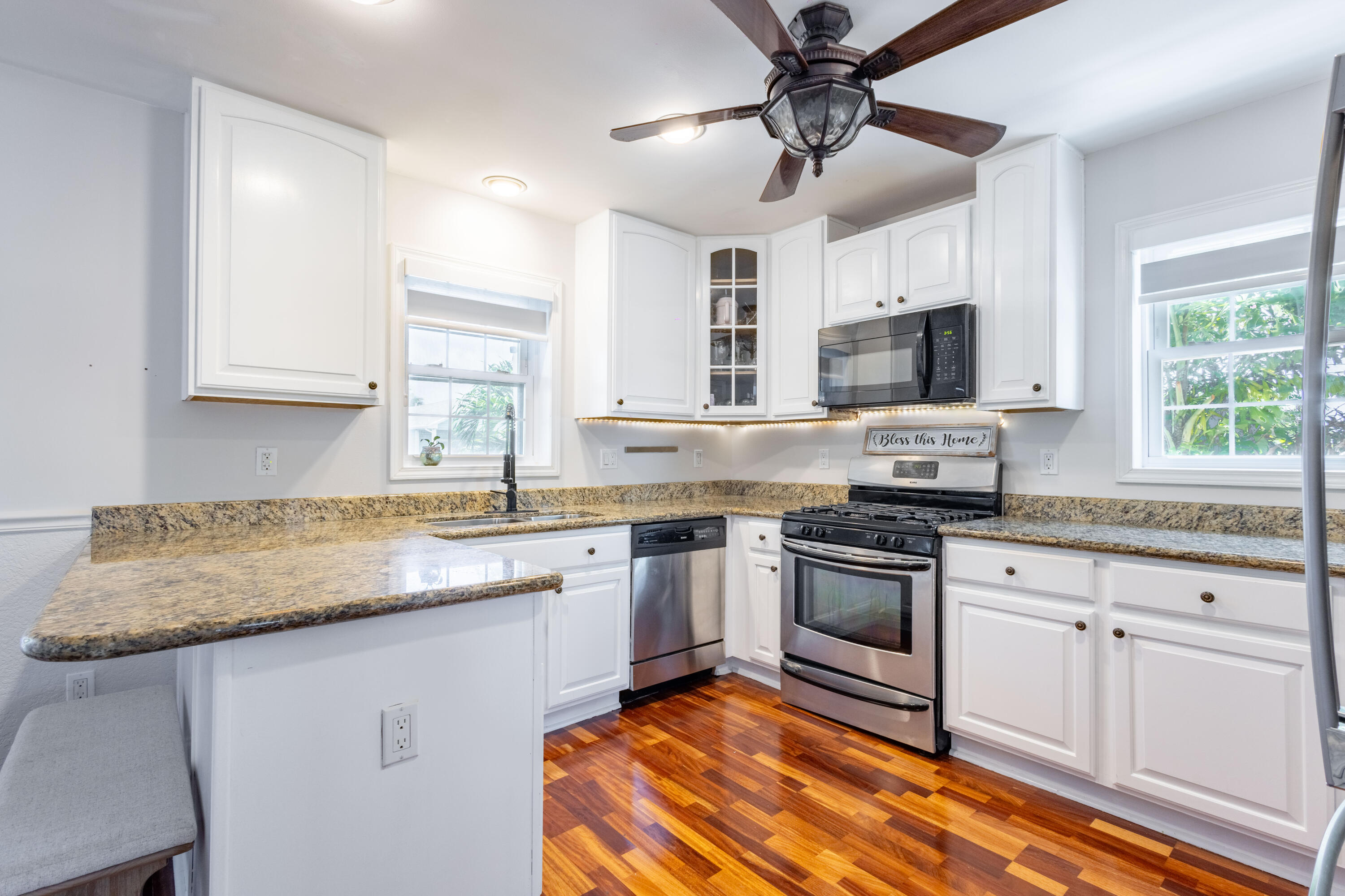 255 Mars Lane Key West, FL 33040 - Photo 10 of 43 a kitchen with stainless steel appliances granite countertop a sink and stove top oven