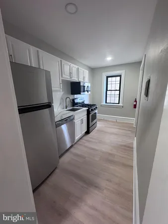 a kitchen with a refrigerator a stove top oven a sink and dishwasher