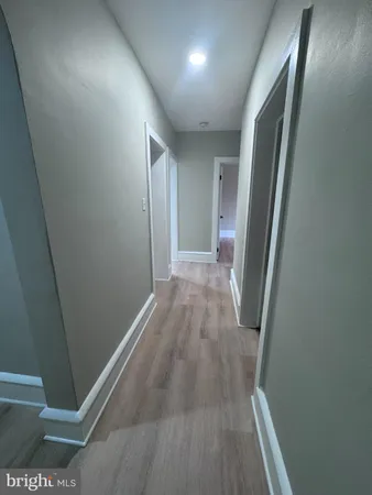 a view of hallway with wooden floor