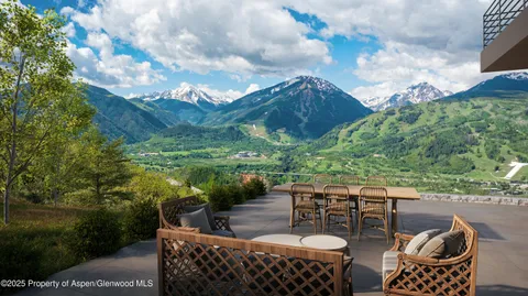 a view of a roof deck with furniture