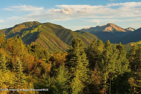 a view of mountain with sunset