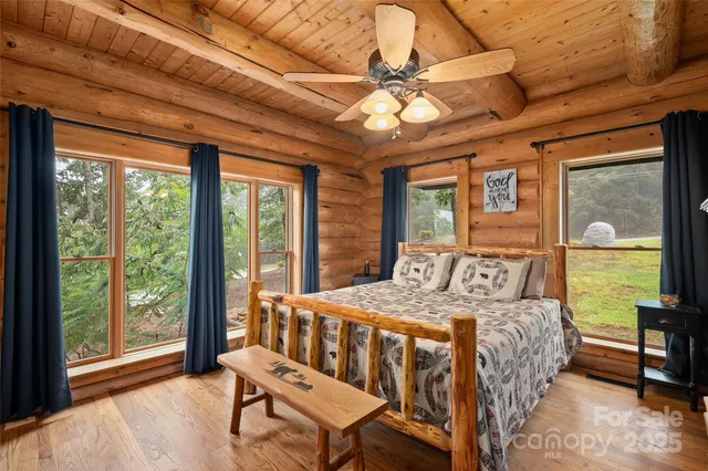 a bedroom with a bed next to a large window