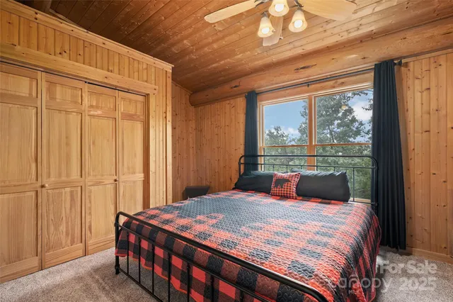 a bed sitting in a bedroom next to a window