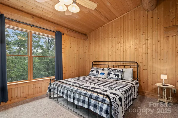 a bedroom with a bed and a large window