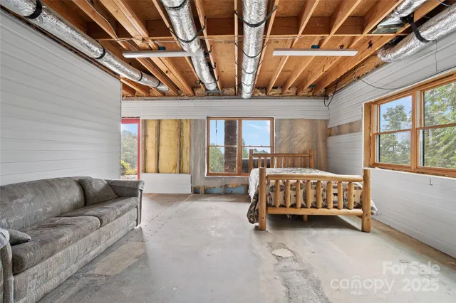 a bedroom with a bed couch and window
