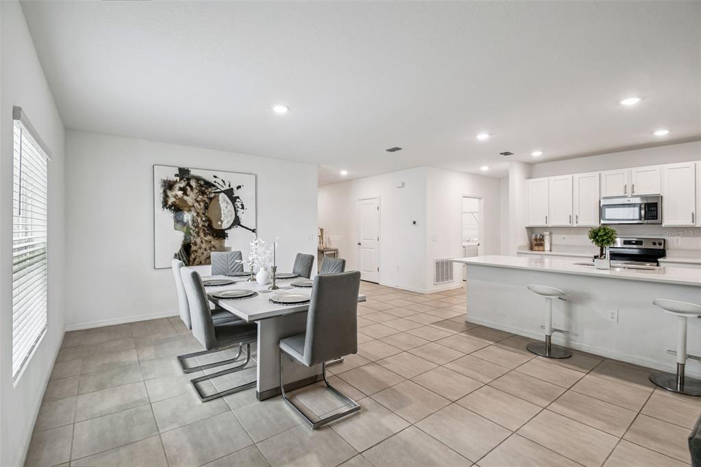 136 Citrine Loop Kissimmee, FL 34758 - Photo 11 of 28 a kitchen with stainless steel appliances kitchen island granite countertop a sink and cabinets