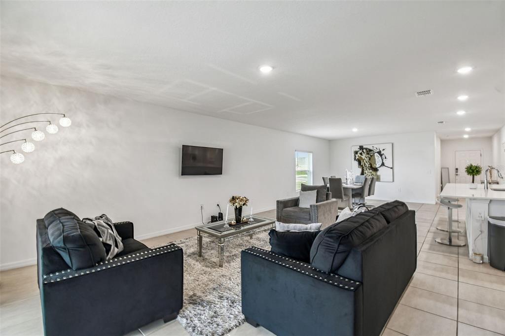 136 Citrine Loop Kissimmee, FL 34758 - Photo 12 of 28 a living room with furniture and a flat screen tv