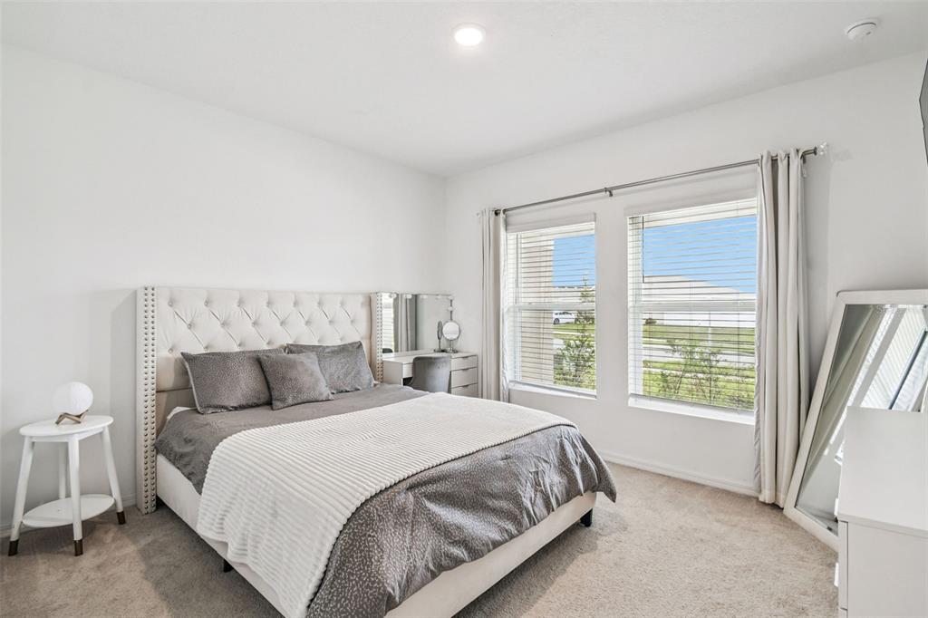 136 Citrine Loop Kissimmee, FL 34758 - Photo 13 of 28 a bedroom with a bed and a large window