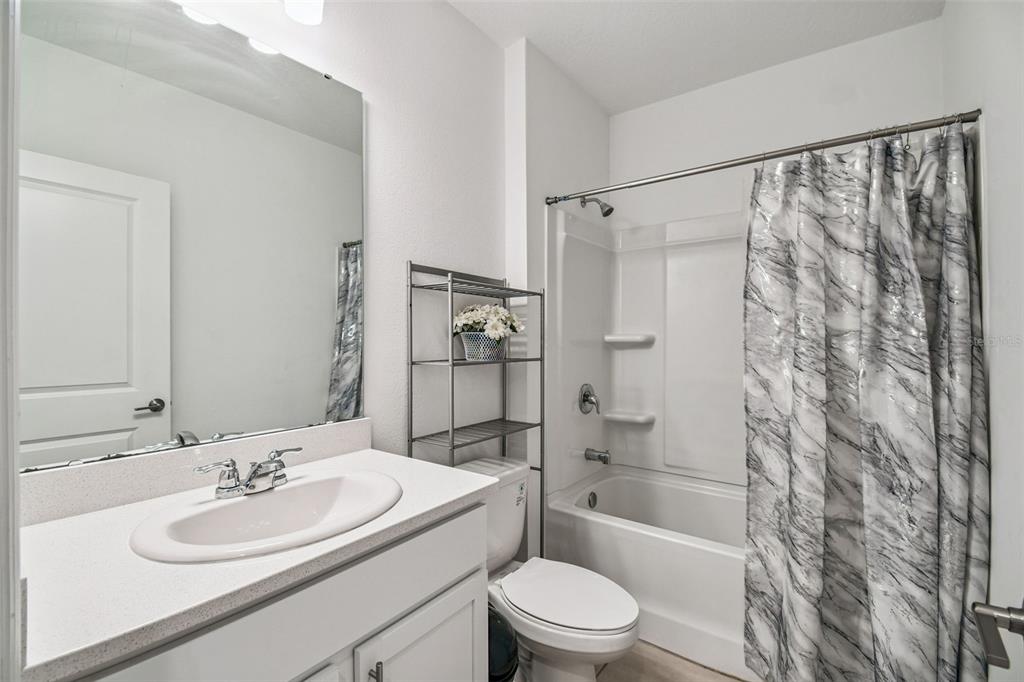 136 Citrine Loop Kissimmee, FL 34758 - Photo 14 of 28 a bathroom with a sink a toilet and shower