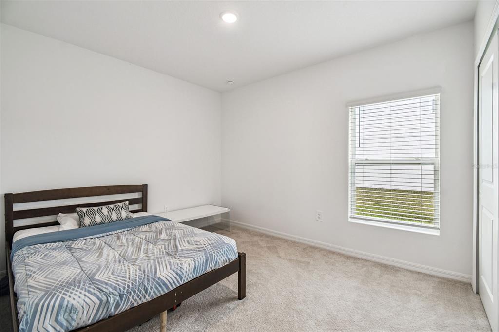 136 Citrine Loop Kissimmee, FL 34758 - Photo 16 of 28 a bedroom with a bed and window