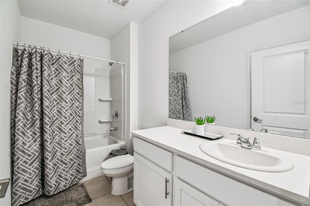 136 Citrine Loop Kissimmee, FL 34758 - Photo 17 of 28 a bathroom with a granite countertop sink toilet and shower