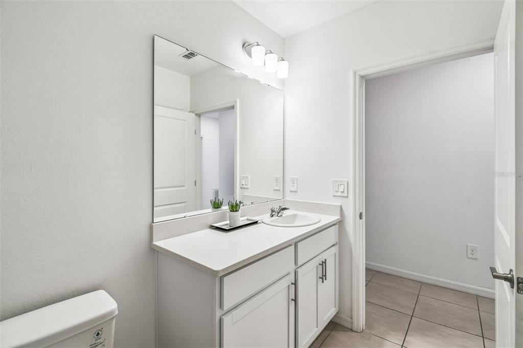 136 Citrine Loop Kissimmee, FL 34758 - Photo 18 of 28 a bathroom with a sink and a mirror