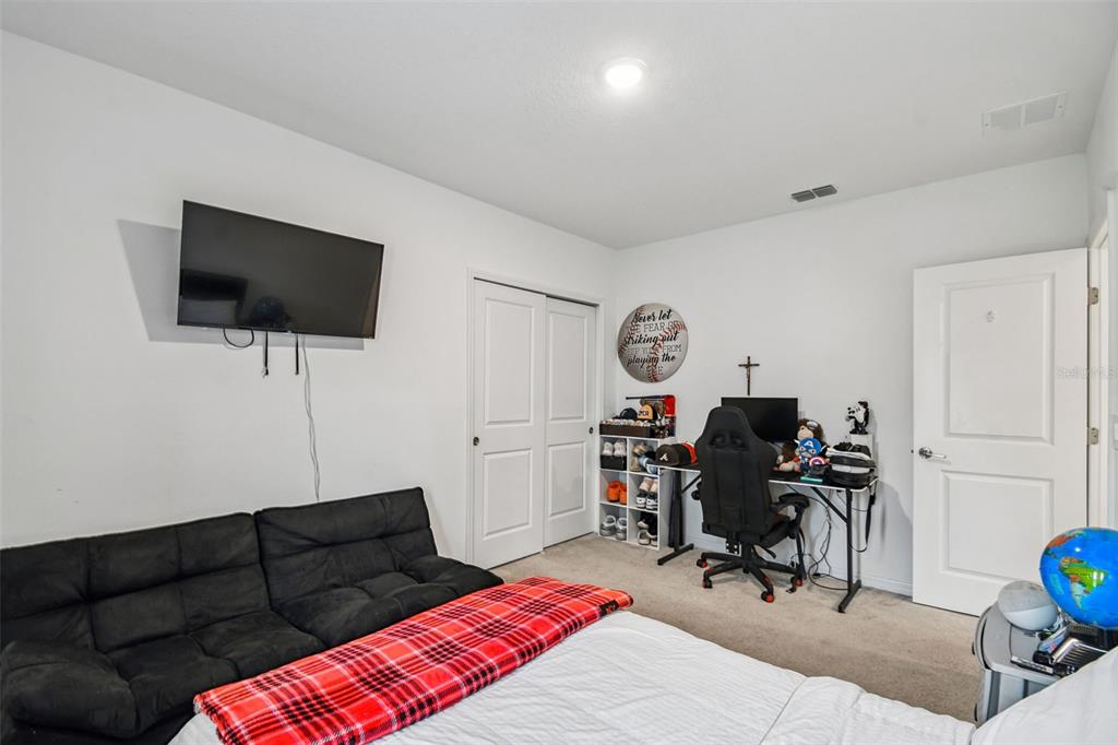 136 Citrine Loop Kissimmee, FL 34758 - Photo 19 of 28 a living room with furniture and a flat screen tv