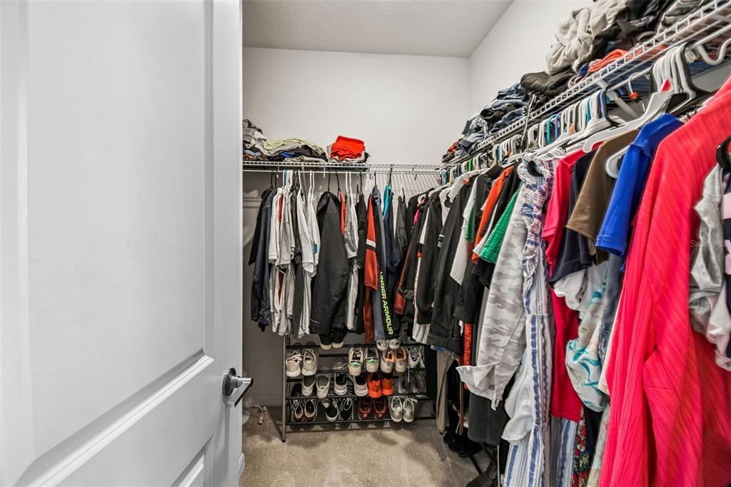 136 Citrine Loop Kissimmee, FL 34758 - Photo 22 of 28 a view of walk in closet with clothes