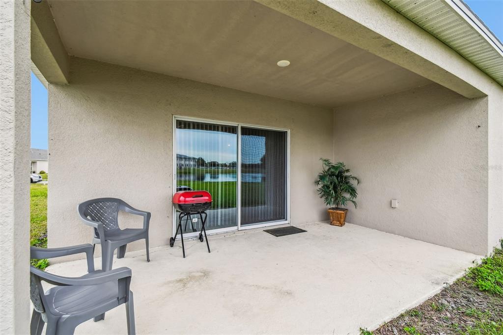 136 Citrine Loop Kissimmee, FL 34758 - Photo 25 of 28 a view of a chairs and table in a backyard