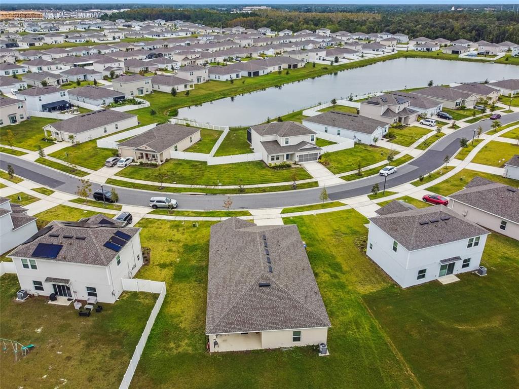 136 Citrine Loop Kissimmee, FL 34758 - Photo 28 of 28 an aerial view of a house with a garden and lake view