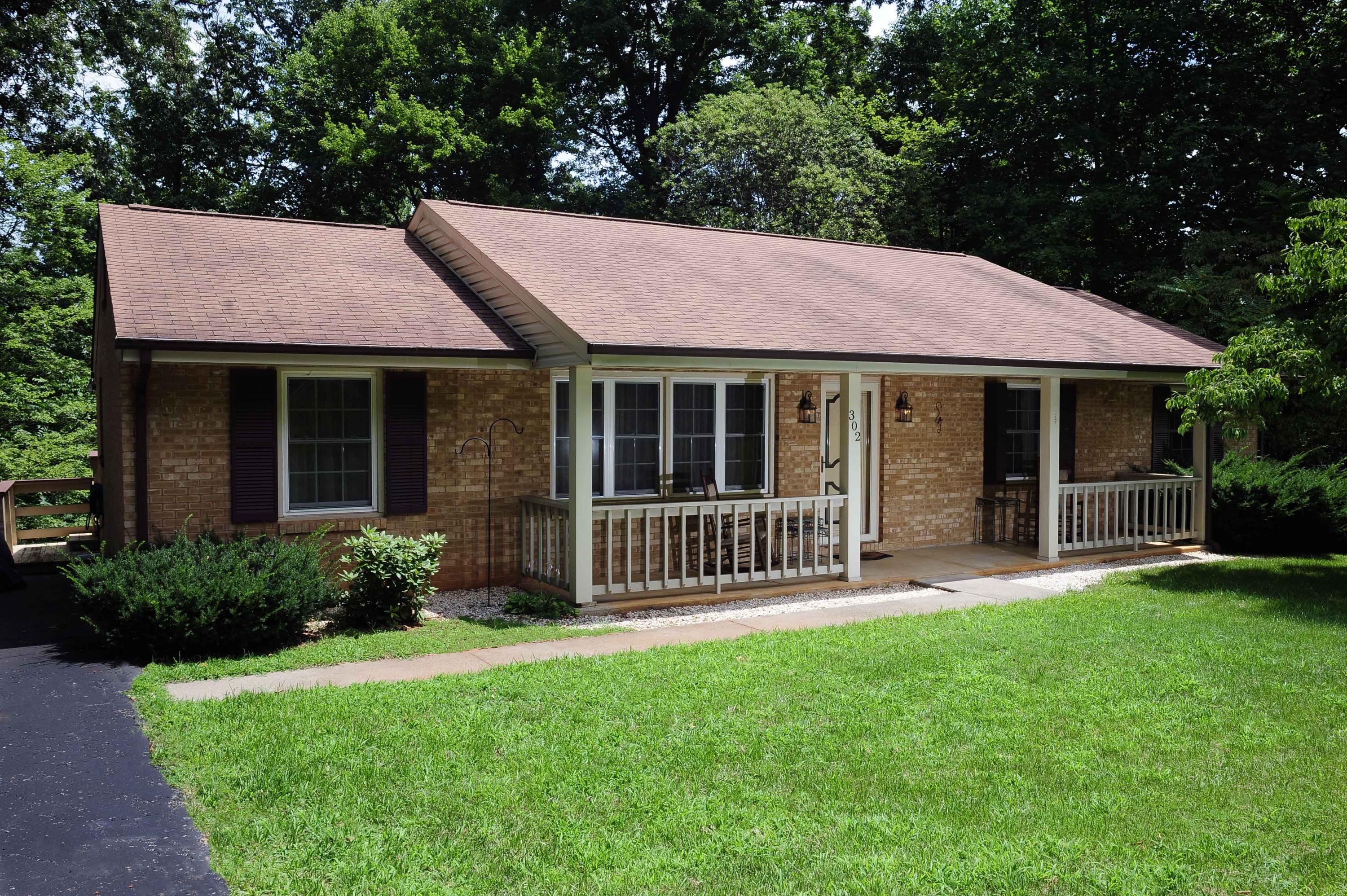 302 Pin Oak Drive Blue Ridge, VA 24064 - Photo 1 of 18 a front view of a house with a garden and porch
