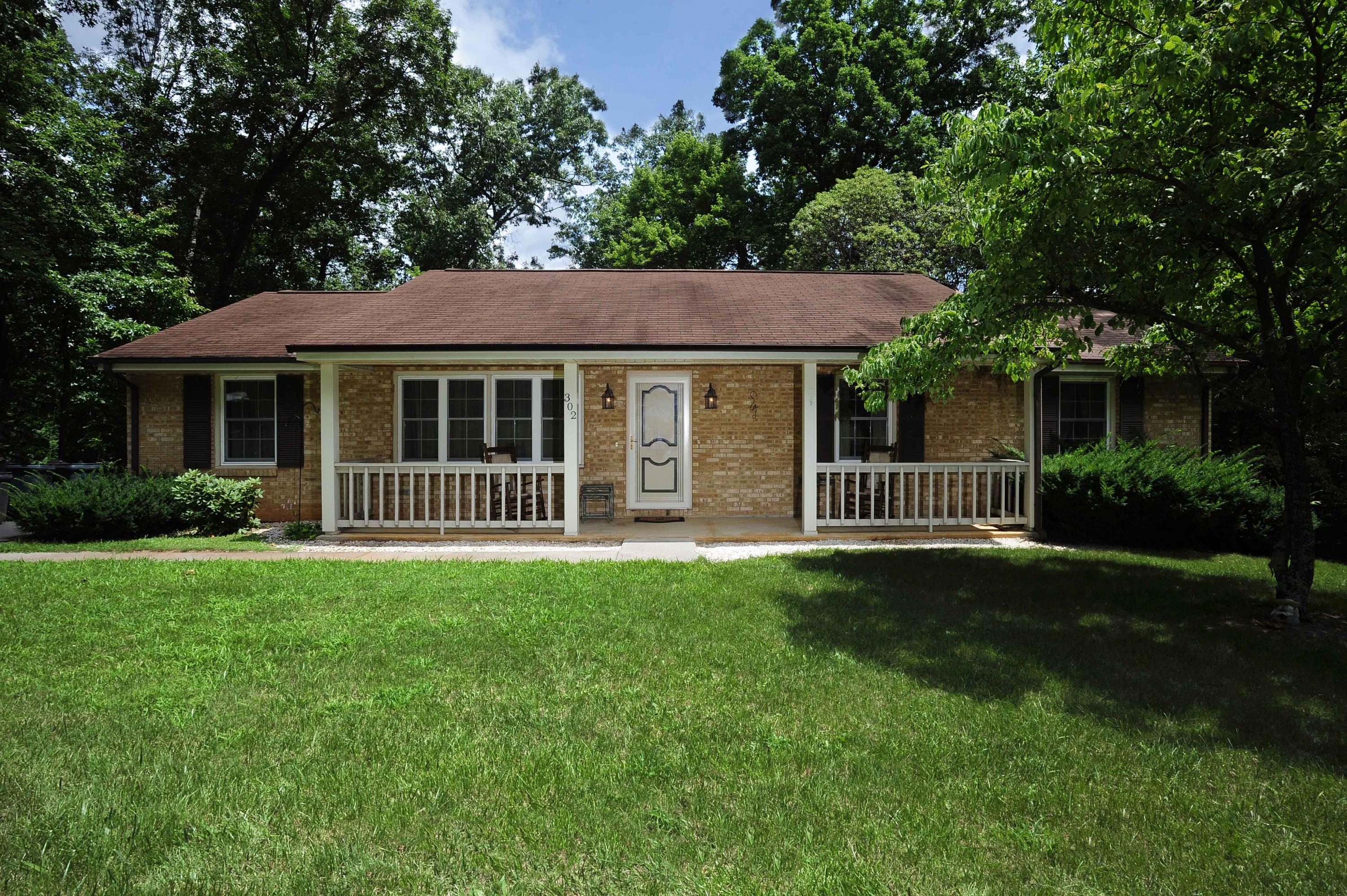 302 Pin Oak Drive Blue Ridge, VA 24064 - Photo 2 of 18 a front view of a house with a garden
