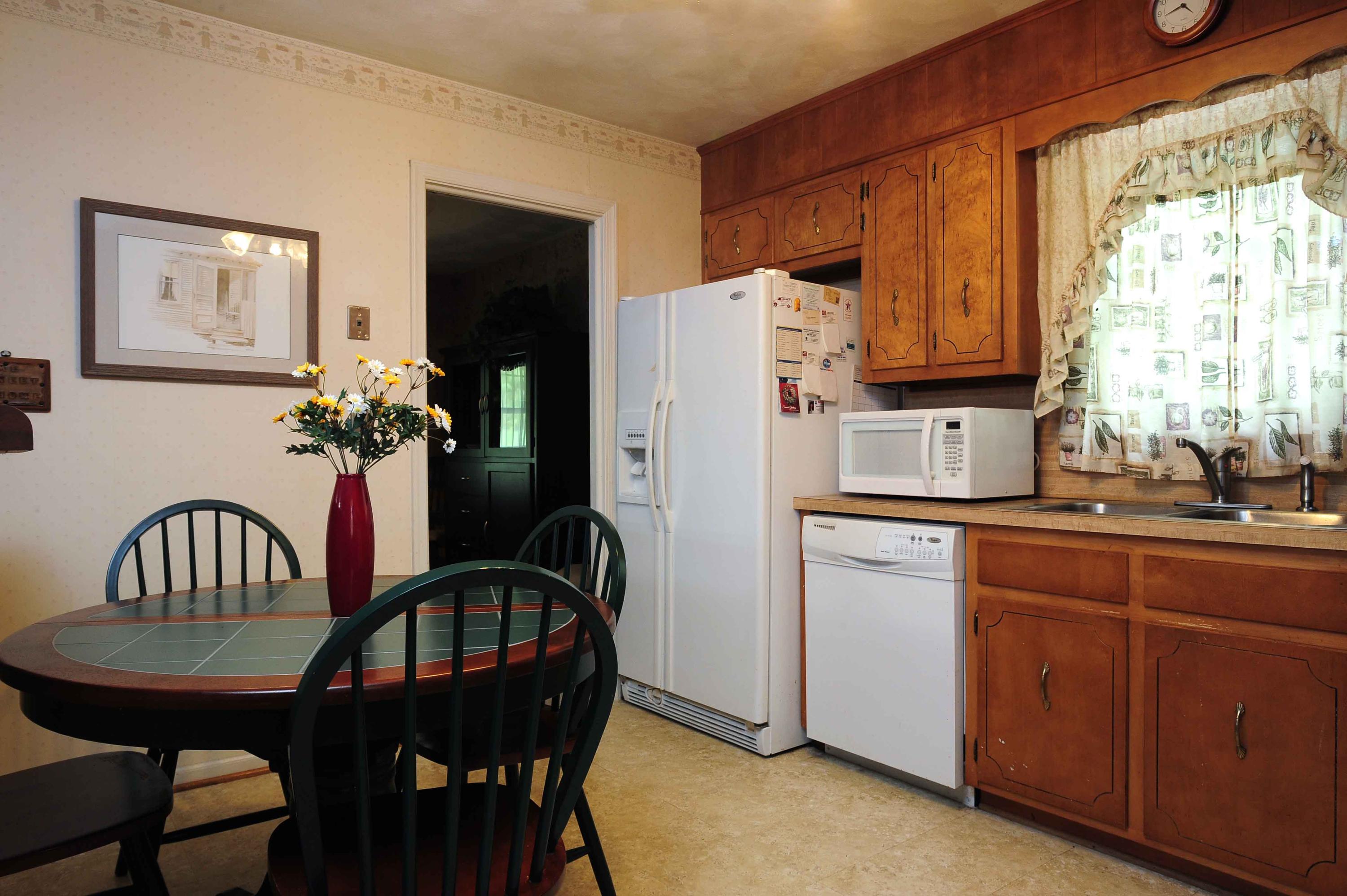 302 Pin Oak Drive Blue Ridge, VA 24064 - Photo 11 of 18 a kitchen with a table chairs and refrigerator