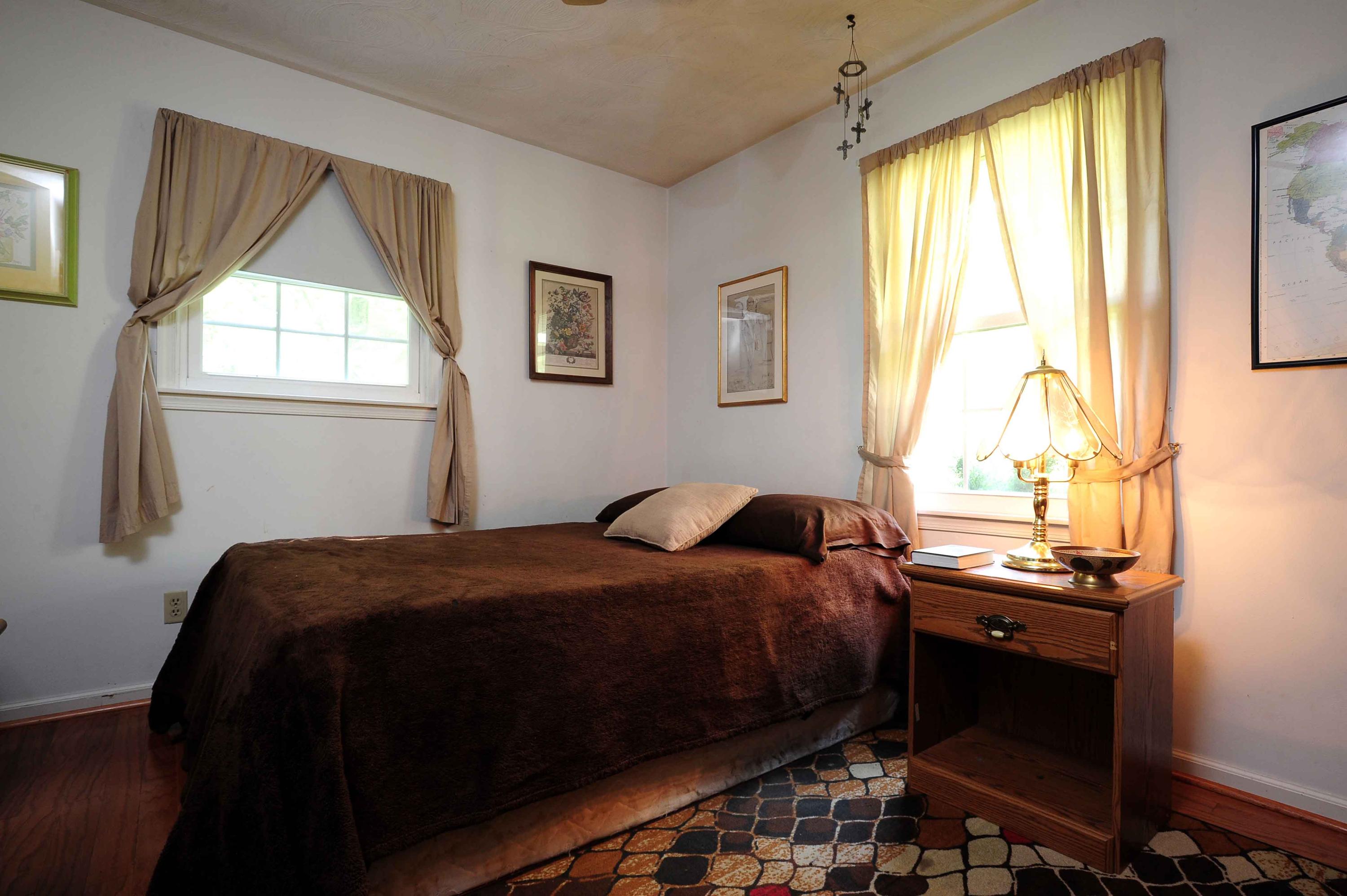 302 Pin Oak Drive Blue Ridge, VA 24064 - Photo 14 of 18 a bedroom with a bed and a window