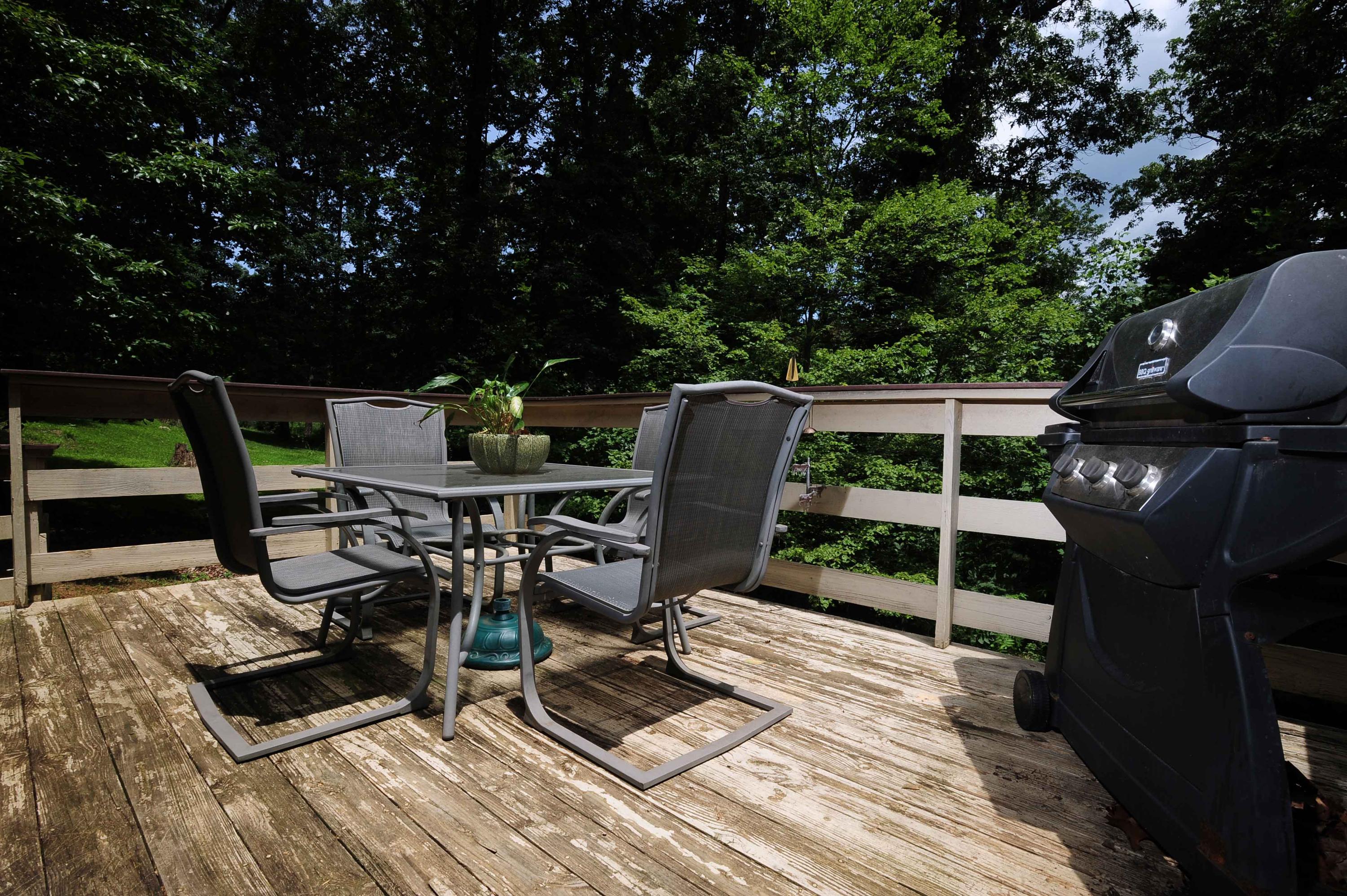 302 Pin Oak Drive Blue Ridge, VA 24064 - Photo 5 of 18 a view of deck a patio with table and chairs with wooden floor and fence