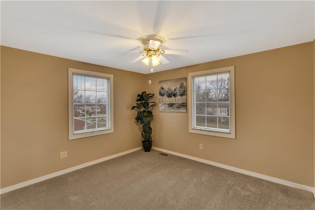 210 Gotham Lane Monroeville, PA 15146 - Photo 20 of 31 an empty room with windows and chandelier fan