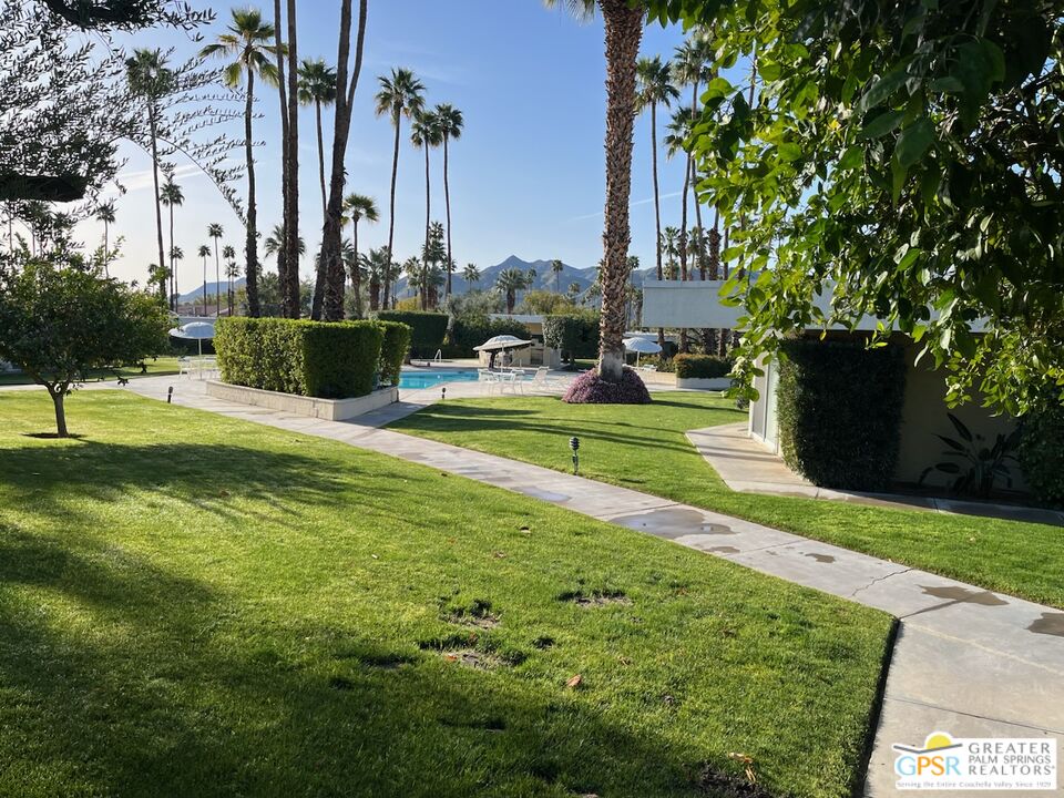 1855 Ramon Road, Unit 4 Palm Springs, CA 92264 - Photo 3 of 39 a view of a fountain in front of a house