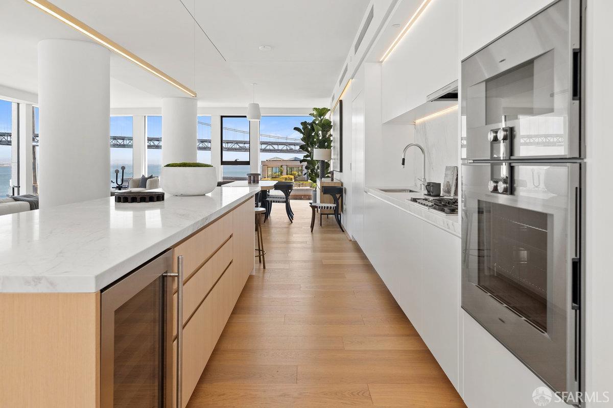 1 Steuart Lane, Unit 1001 San Francisco, CA 94105 - Photo 20 of 60 a large open kitchen with granite countertop a large counter top a sink a stove and a refrigerator
