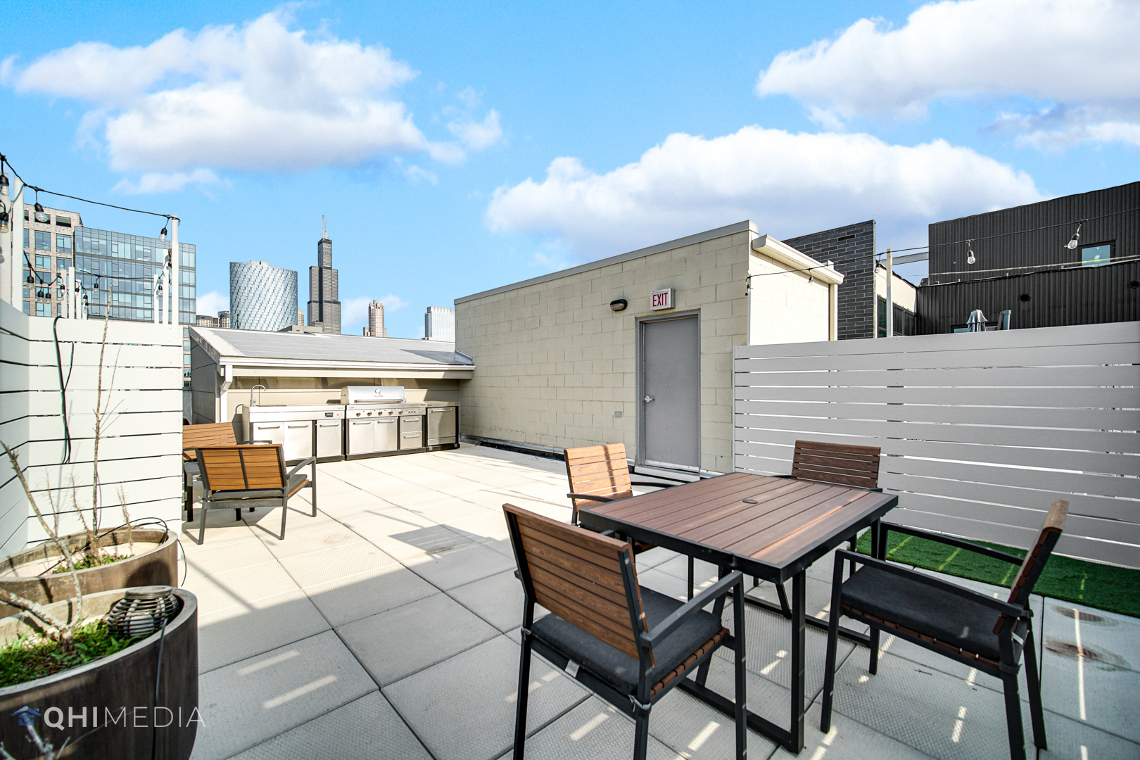 16 North Carpenter Street, Unit PHN Chicago, IL 60607 - Photo 20 of 25 a view of a patio with table and chairs and wooden floor