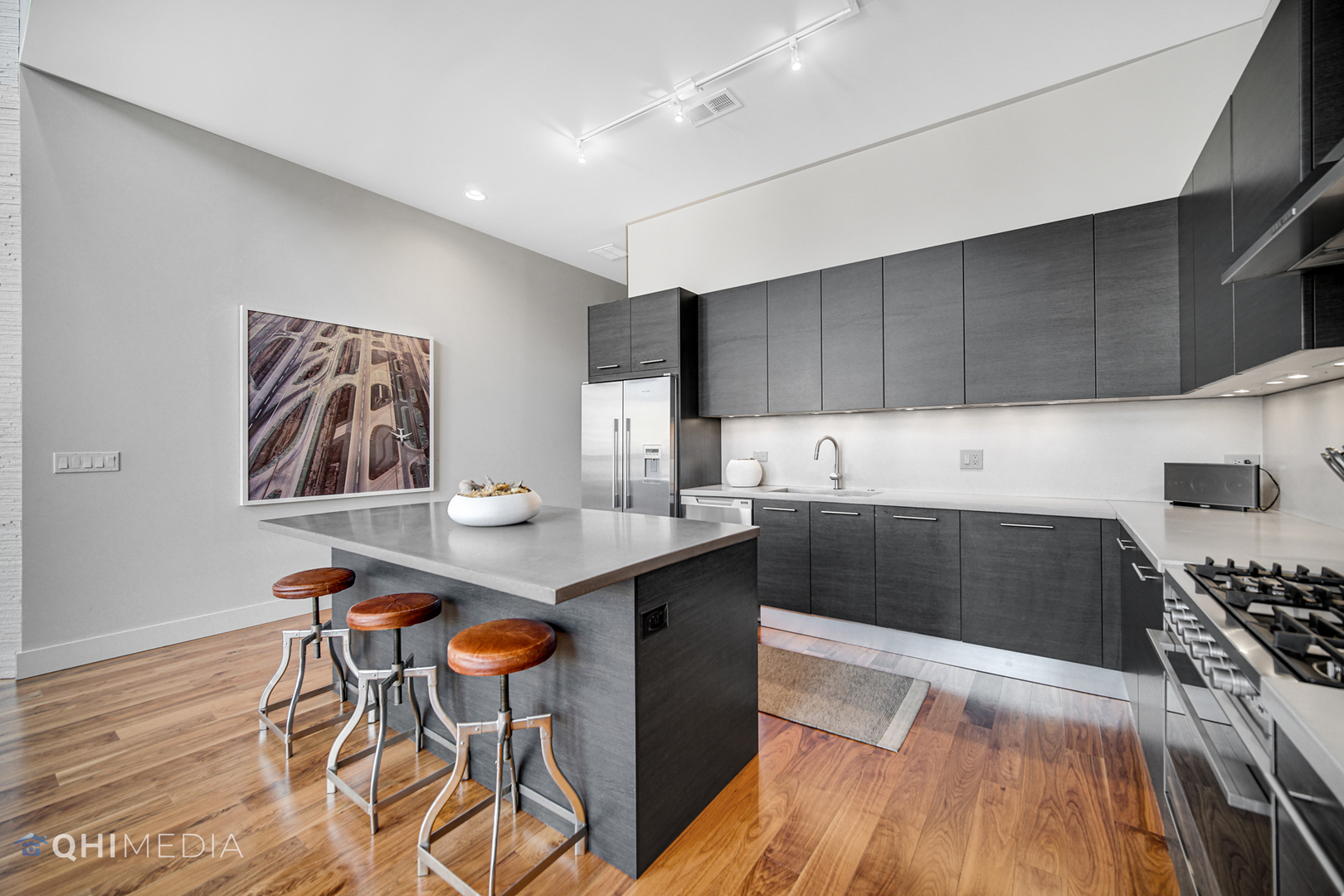 16 North Carpenter Street, Unit PHN Chicago, IL 60607 - Photo 8 of 25 a kitchen with stainless steel appliances a stove a sink a refrigerator and cabinets