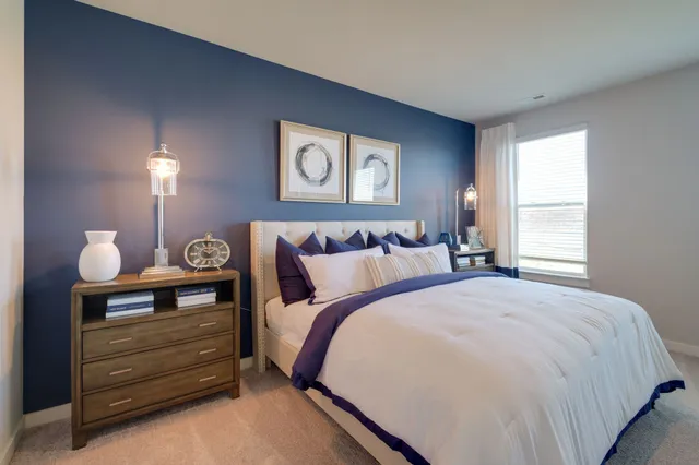 a bedroom with a bed and a lamp