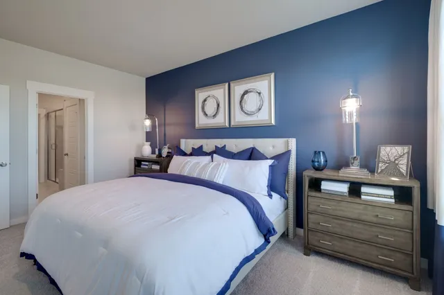 a bedroom with a bed and a night stand