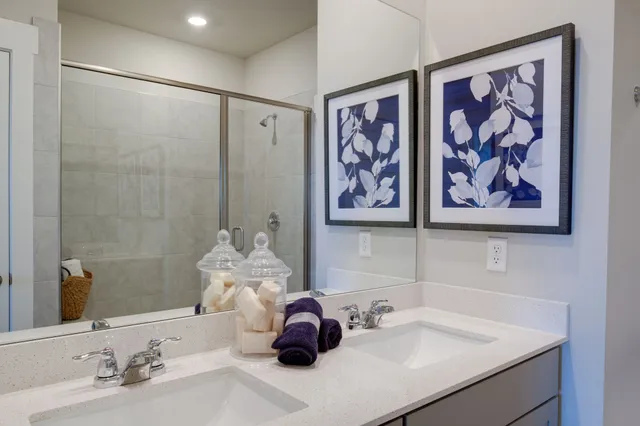 a bathroom with a sink mirror and vanity