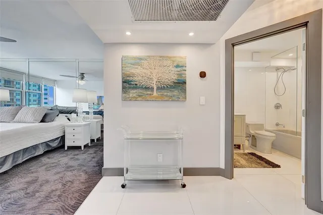 a bathroom with a sink a toilet and a large mirror