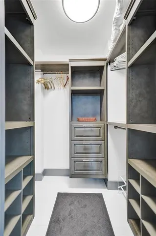 a view of a kitchen with a sink and chairs