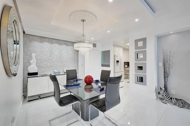 a dining room with furniture a chandelier and window
