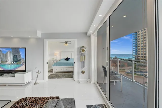 a bedroom with furniture and a large window