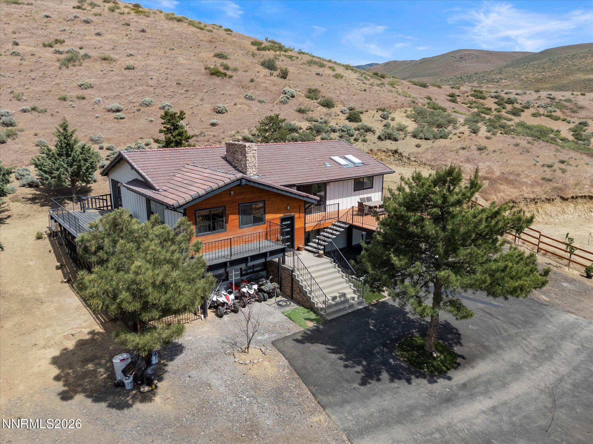 an aerial view of a house with a mountain