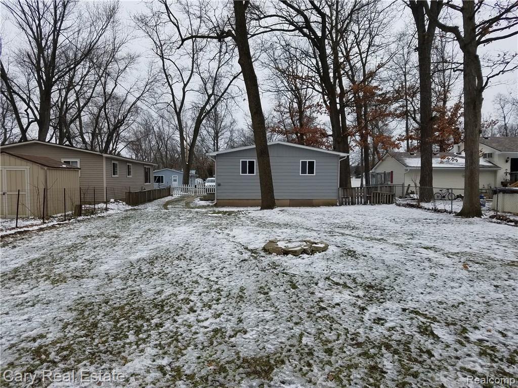 636 West Baker Road Highland, MI 48357 - Photo 3 of 22 Rear view~ Huge fence back yard