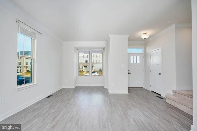 a view of a kitchen with wooden floor and a kitchen