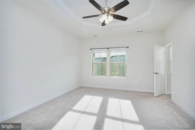 a view of a livingroom with a window and a ceiling fan