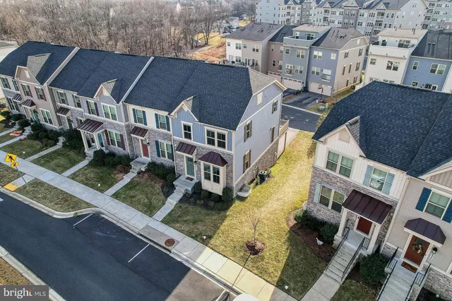 an aerial view of residential houses with yard
