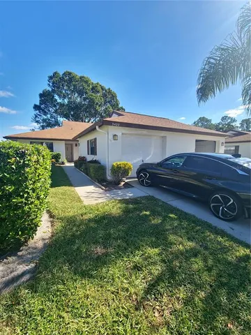 a view of a house with backyard sitting area and garden