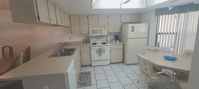 a kitchen with a sink a stove cabinets and a counter top space