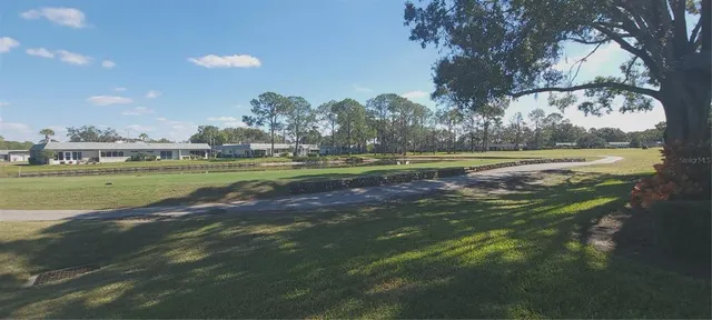 a view of a golf course with a lake view