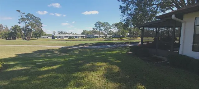 a view of yard with swimming pool and outdoor seating