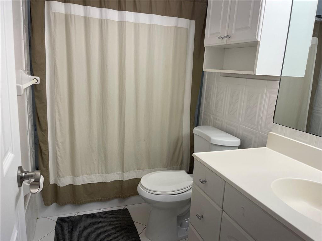 22813 Southwest 54th Way Boca Raton, FL 33433 - Photo 8 of 10 a white toilet sitting next to a bathroom sink
