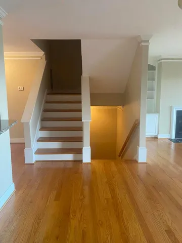 a view of entryway and hall with wooden floor