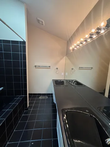 a view of a room with gym equipment and a chandelier